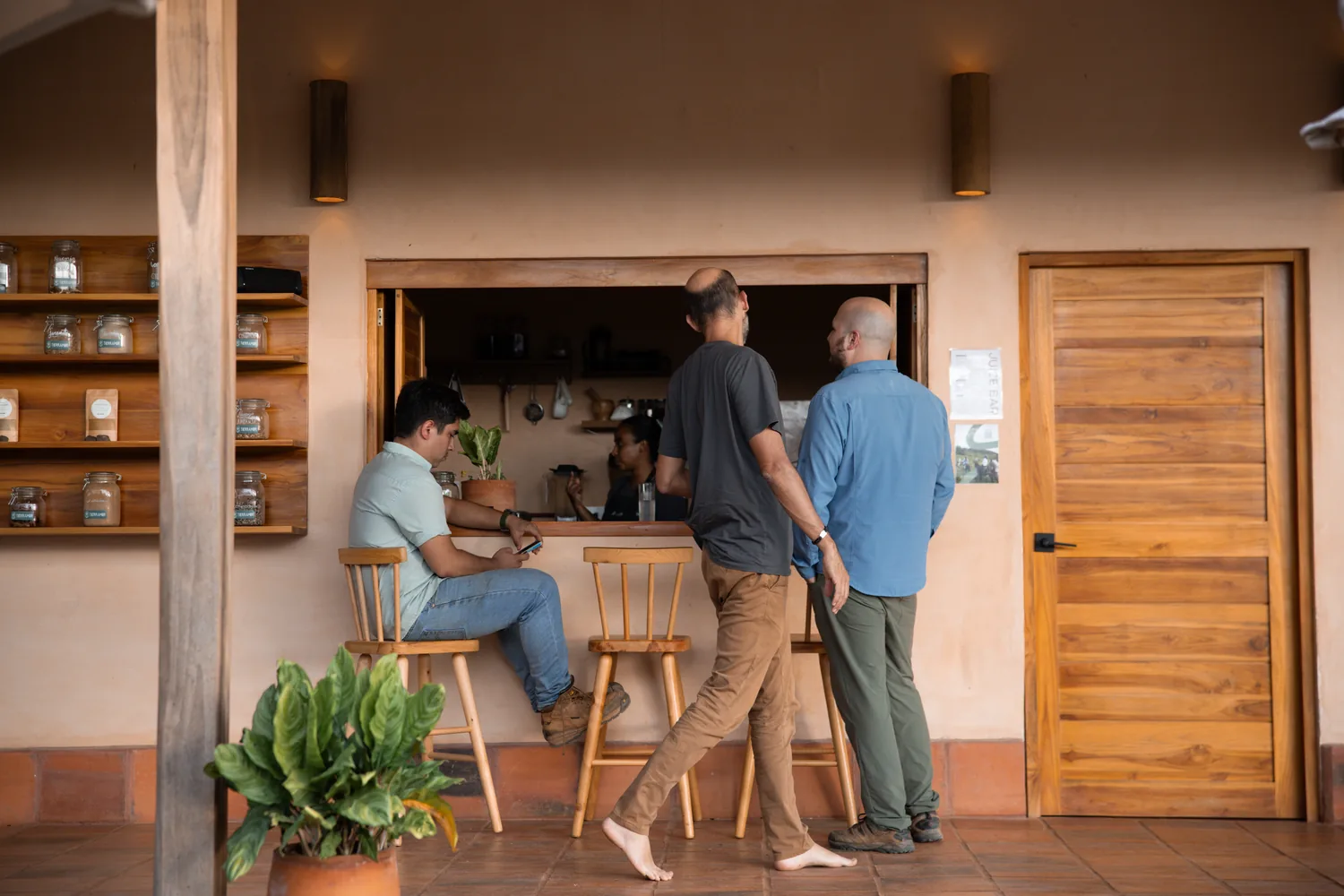 Three people talking at the open counter of the farm kitchen