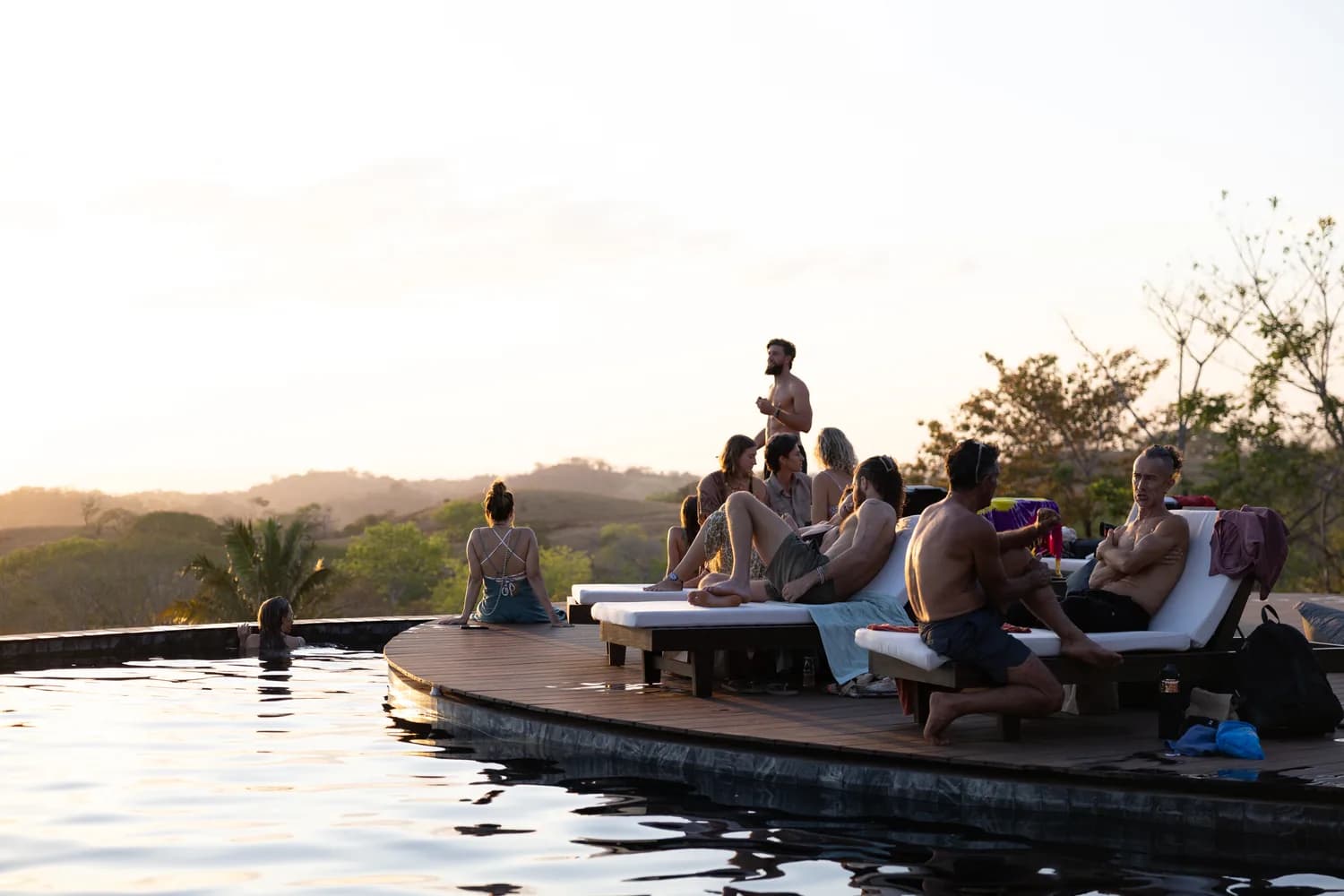 Residents gathered on the pool deck as the sun sets over the hills